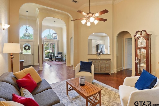 502 Northcreek Dr, Chandler, TX 75758 - living area featuring arched walkways, wood finished floors, ornamental molding, a high ceiling, and a ceiling fan
