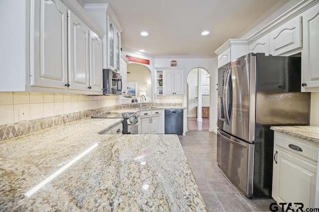 502 Northcreek Dr, Chandler, TX 75758 - kitchen with appliances with stainless steel finishes, arched walkways, a sink, tasteful backsplash, and open shelves