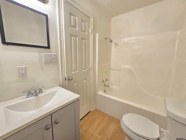 201 W Paschal St, Troup, TX 75789 - full bathroom with toilet, wood finished floors, vanity, and shower / tub combination