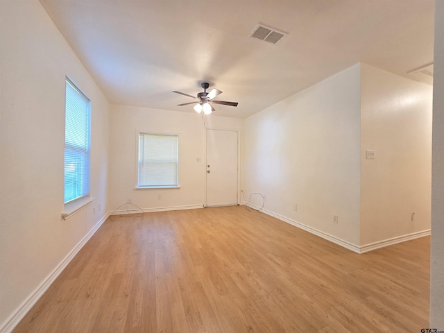 201 W Paschal St, Troup, TX 75789 - empty room with light wood-type flooring, ceiling fan, and baseboards