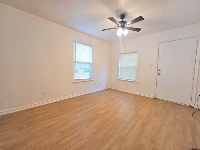 201 W Paschal St, Troup, TX 75789 - empty room with light wood finished floors, a ceiling fan, and baseboards