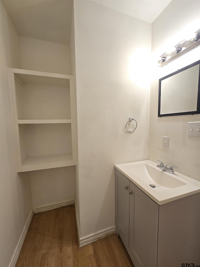 201 W Paschal St, Troup, TX 75789 - bathroom with wood finished floors, vanity, and baseboards