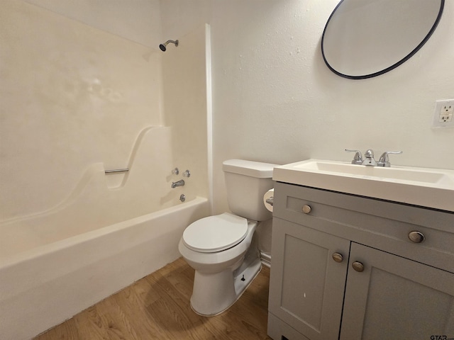 201 W Paschal St, Troup, TX 75789 - bathroom with wood finished floors, toilet, vanity, and bathing tub / shower combination