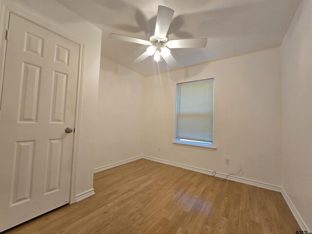 201 W Paschal St, Troup, TX 75789 - unfurnished room featuring light wood-style floors, ceiling fan, and baseboards