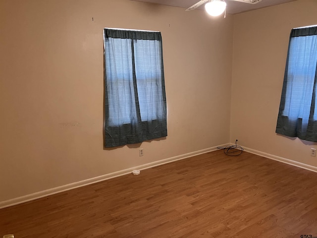 unfurnished room with hardwood / wood-style flooring and ceiling fan