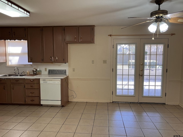 kitchen featuring sink, light tile patterned floors, ceiling fan, white dishwasher, and french doors