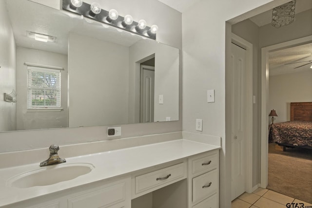 bathroom featuring vanity, tile patterned flooring, and a textured ceiling