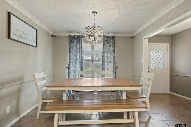 tiled dining space featuring an inviting chandelier, crown molding, and a textured ceiling