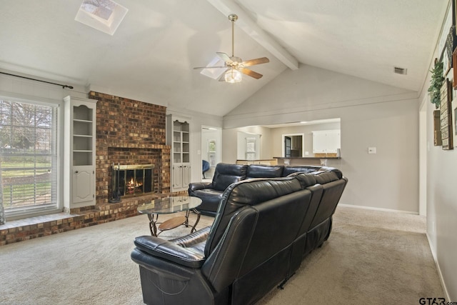 carpeted living room with ceiling fan, plenty of natural light, a fireplace, and lofted ceiling with beams