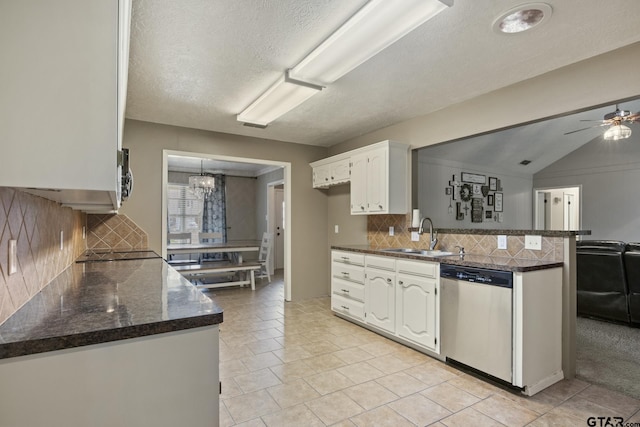 kitchen with white cabinetry, sink, stainless steel dishwasher, and kitchen peninsula