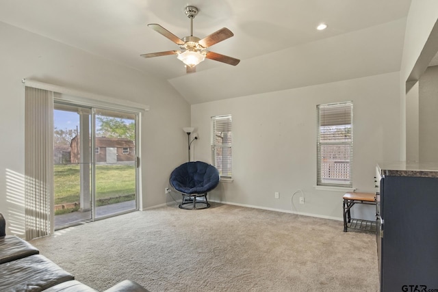 sitting room featuring vaulted ceiling, light carpet, and a wealth of natural light