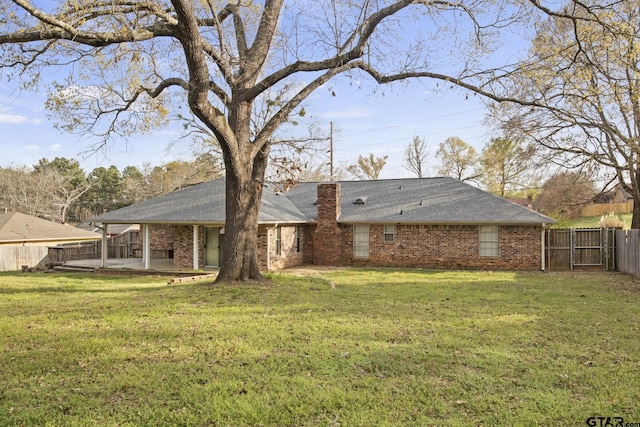 back of property featuring a patio area and a lawn