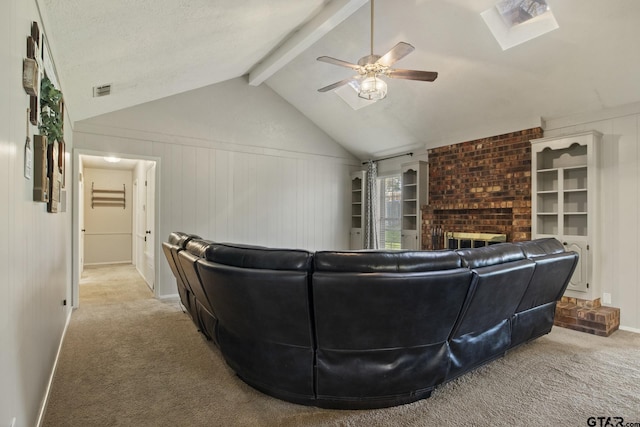 carpeted living room featuring vaulted ceiling with beams, a fireplace, a textured ceiling, and ceiling fan