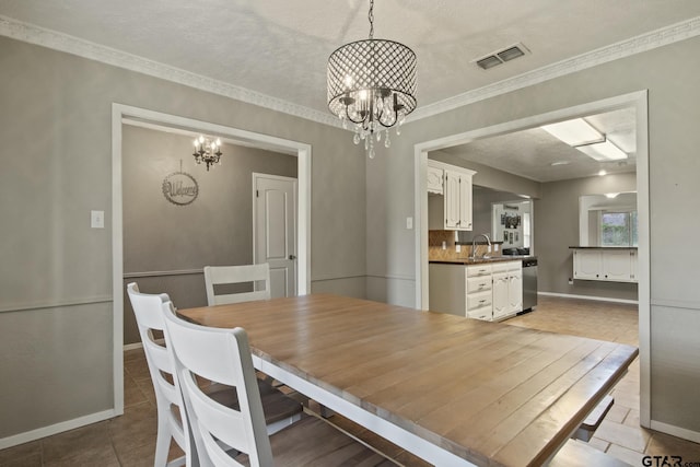 dining space featuring light tile patterned floors, a textured ceiling, sink, and a chandelier