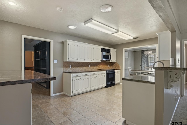 kitchen featuring range with electric cooktop, white cabinetry, sink, backsplash, and kitchen peninsula