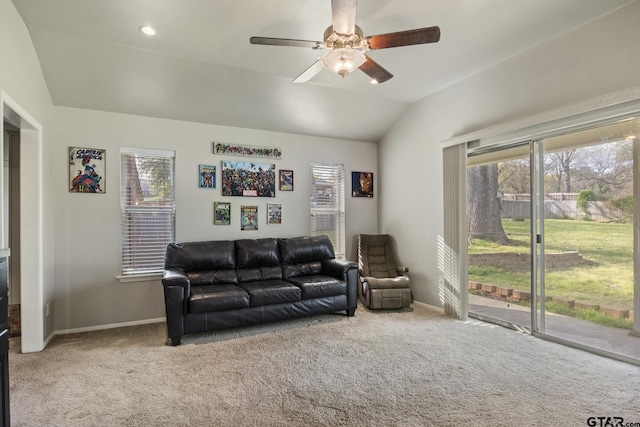 carpeted living room featuring ceiling fan and lofted ceiling