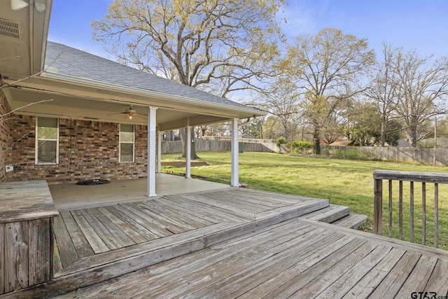 deck with ceiling fan and a yard