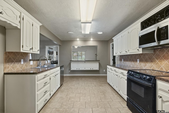 kitchen with stainless steel appliances, sink, white cabinets, and backsplash