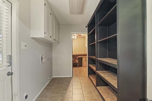 laundry room featuring light tile patterned flooring, cabinets, a textured ceiling, hookup for a washing machine, and ceiling fan