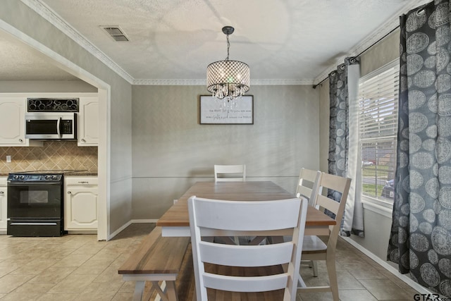 tiled dining area featuring a healthy amount of sunlight, a textured ceiling, and an inviting chandelier