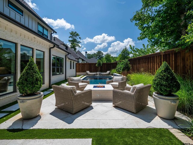 1555 Maple Crk, Tyler, TX 75703 - fenced backyard featuring a fire pit and a patio area