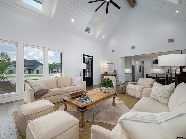 1555 Maple Crk, Tyler, TX 75703 - living room with high vaulted ceiling, light wood-type flooring, a ceiling fan, plenty of natural light, and beamed ceiling