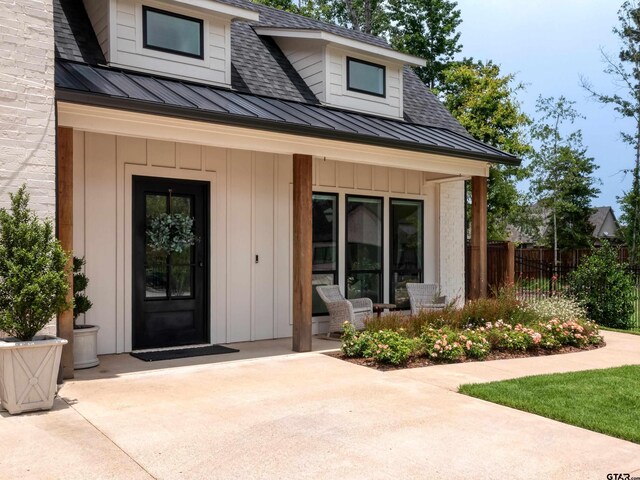 1555 Maple Crk, Tyler, TX 75703 - entrance to property with a standing seam roof, board and batten siding, and roof with shingles