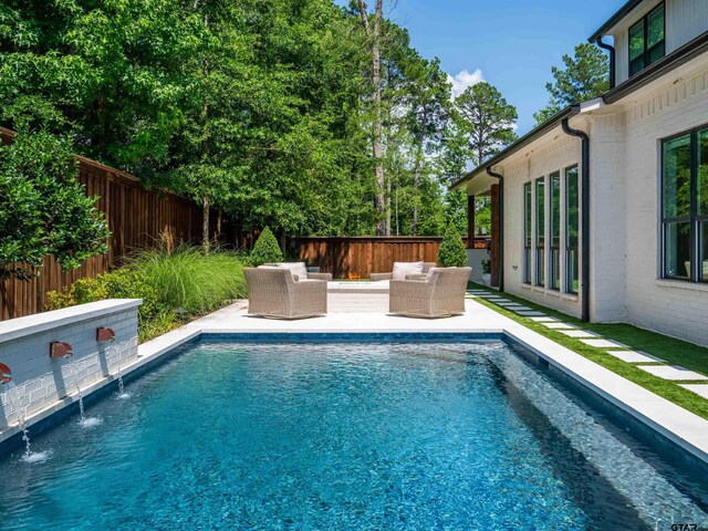 1555 Maple Crk, Tyler, TX 75703 - view of swimming pool featuring a fenced backyard and an outdoor living space
