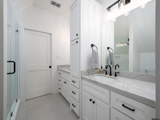 1555 Maple Crk, Tyler, TX 75703 - bathroom with vanity, tile patterned flooring, a shower stall, and lofted ceiling