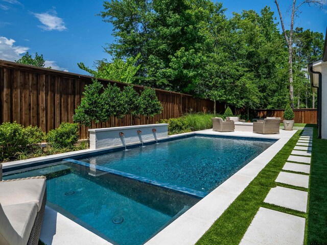 1555 Maple Crk, Tyler, TX 75703 - view of swimming pool featuring outdoor lounge area, a fenced backyard, a pool with connected hot tub, and a patio area