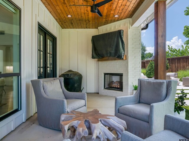 1555 Maple Crk, Tyler, TX 75703 - view of patio / terrace with an outdoor brick fireplace and a ceiling fan
