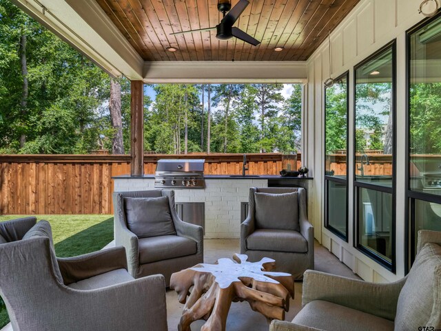 1555 Maple Crk, Tyler, TX 75703 - view of patio / terrace with an outdoor kitchen, a ceiling fan, and view of scattered trees