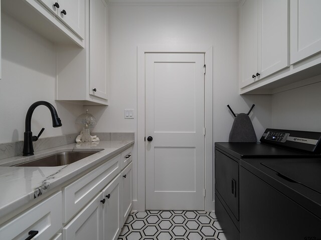 1555 Maple Crk, Tyler, TX 75703 - laundry area with washer and clothes dryer, cabinet space, and light tile patterned floors