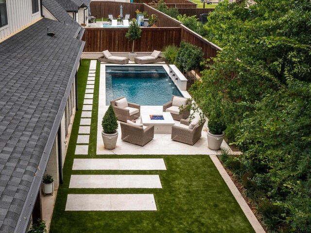 1555 Maple Crk, Tyler, TX 75703 - view of swimming pool featuring an outdoor living space with a fire pit, a fenced backyard, and a patio area
