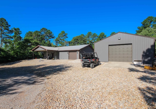 5000 Fm 315 S, Chandler, TX 75758 - view of front of home featuring a garage, an outdoor structure, and gravel driveway