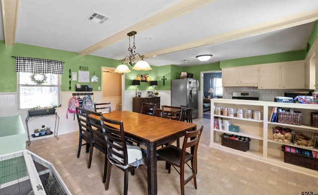 dining area with beam ceiling