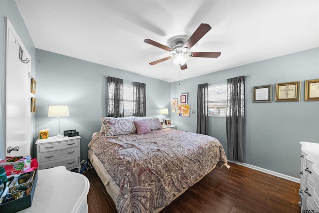 bedroom with dark hardwood / wood-style floors and ceiling fan