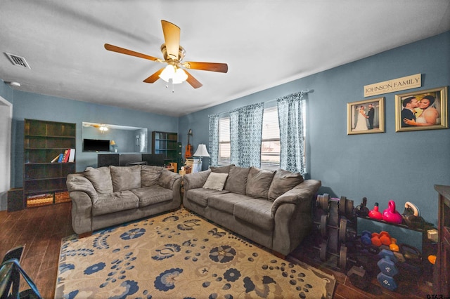 living room with ceiling fan and dark hardwood / wood-style flooring