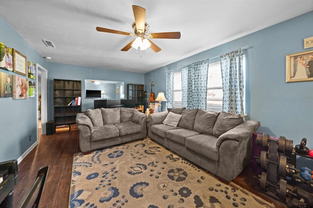 living room featuring dark wood-type flooring and ceiling fan