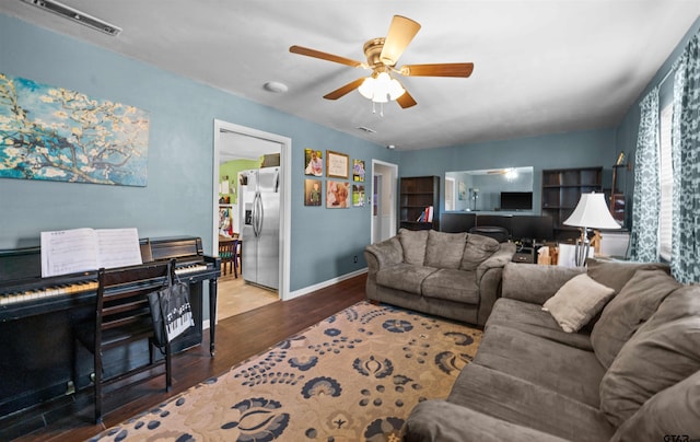 living room featuring hardwood / wood-style flooring and ceiling fan