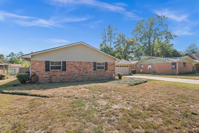 ranch-style home featuring a front lawn and a garage