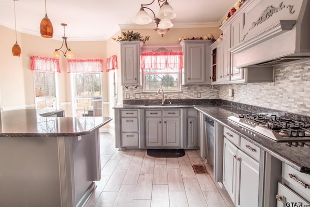 kitchen featuring premium range hood, a sink, gray cabinetry, stainless steel appliances, and a chandelier