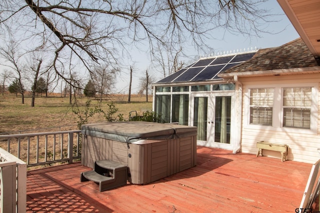 wooden terrace with french doors and a hot tub