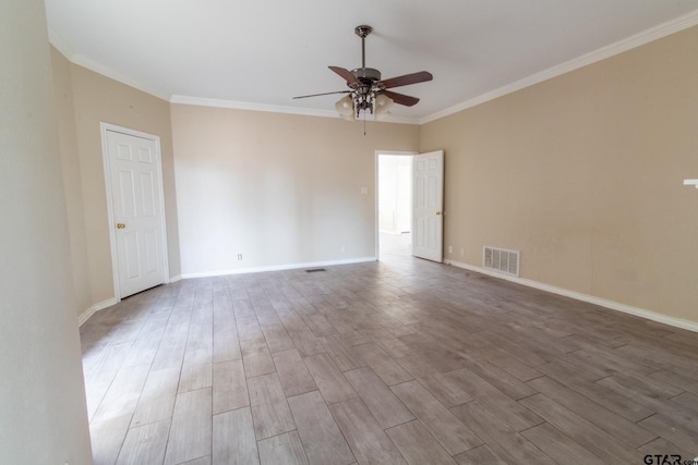 unfurnished room featuring visible vents, crown molding, a ceiling fan, and wood finished floors