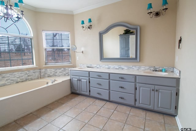 full bath featuring a garden tub, ornamental molding, double vanity, and a sink