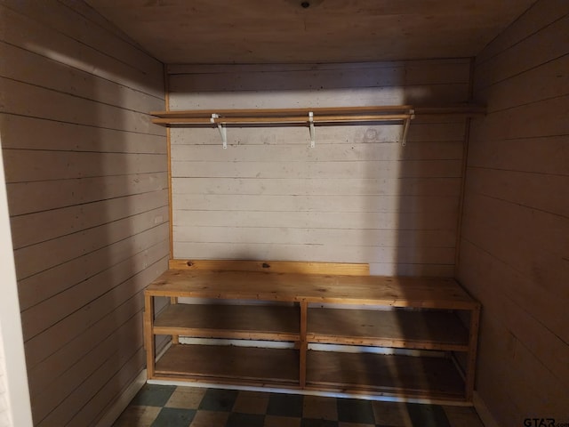 mudroom featuring wooden walls