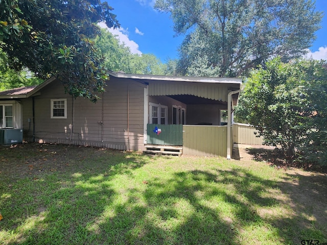 exterior space with a yard and central AC unit