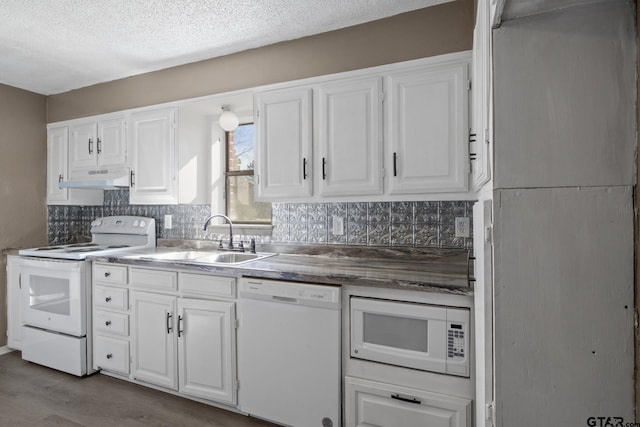 kitchen with white cabinets, under cabinet range hood, a sink, white appliances, and decorative backsplash