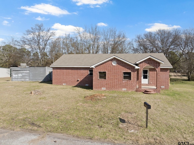 view of side of property featuring brick siding, a lawn, and crawl space