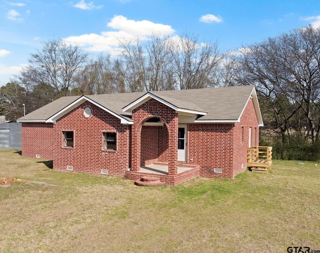 ranch-style house with crawl space, brick siding, a front yard, and roof with shingles